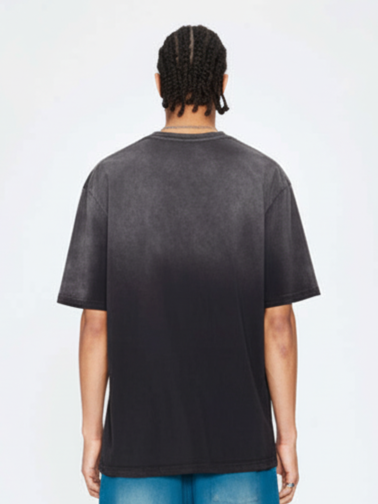 Person wearing a black t-shirt on a white background