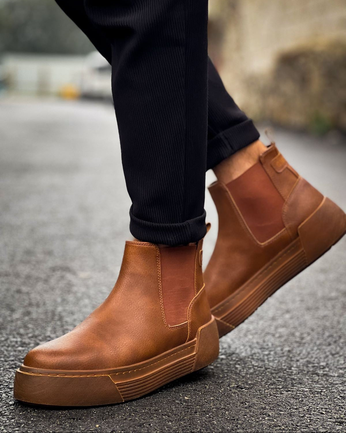 Man wearing Avalon Light Brown Chelsea boots with cushioned platform sole on wet pavement.
