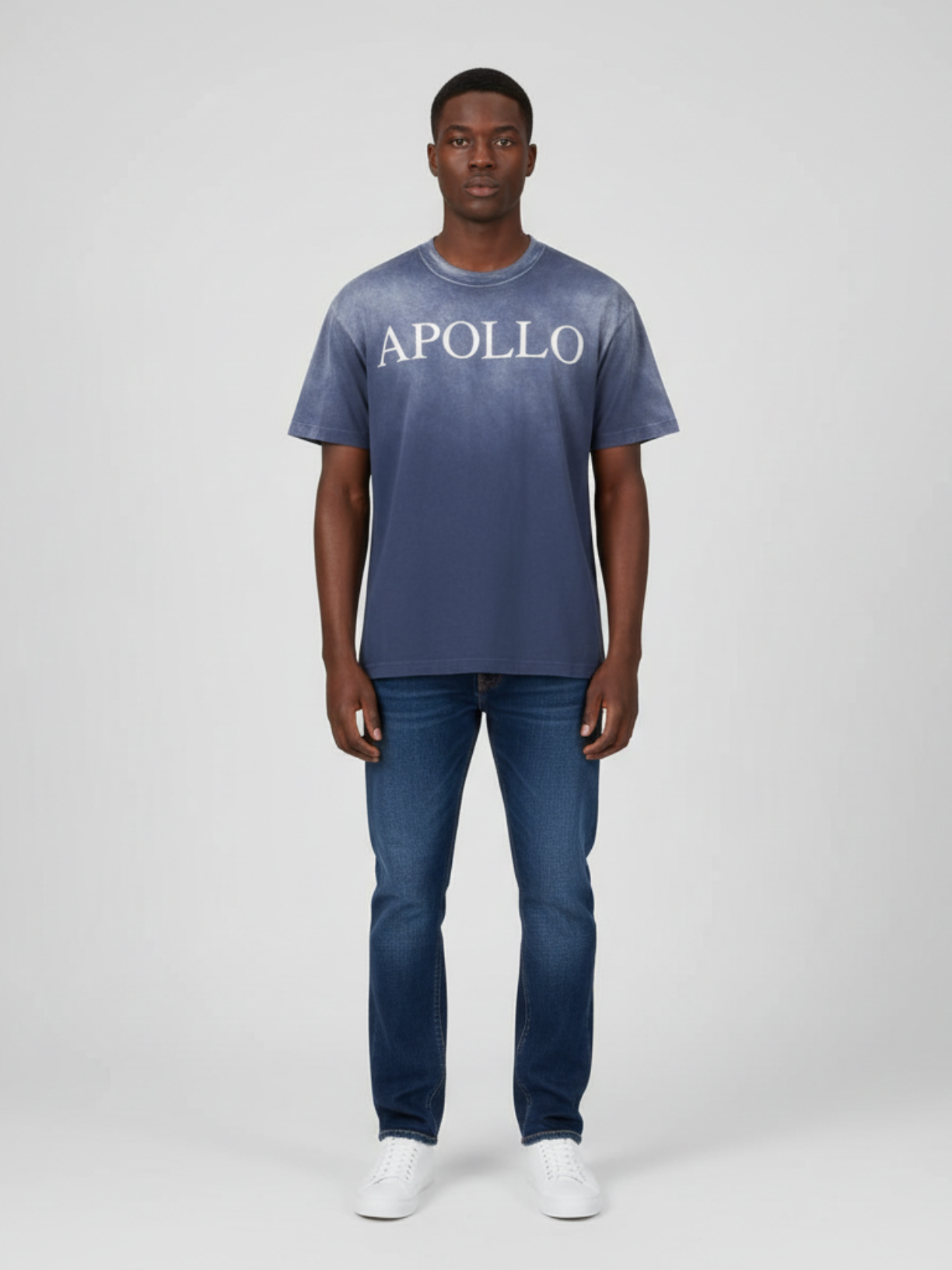 Person wearing a blue t-shirt with 'APOLLO' text and jeans on a white background