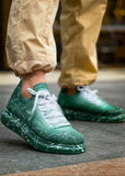Man wearing Torino Green Peak White Mesh sneakers with green gradient and white splatter design.