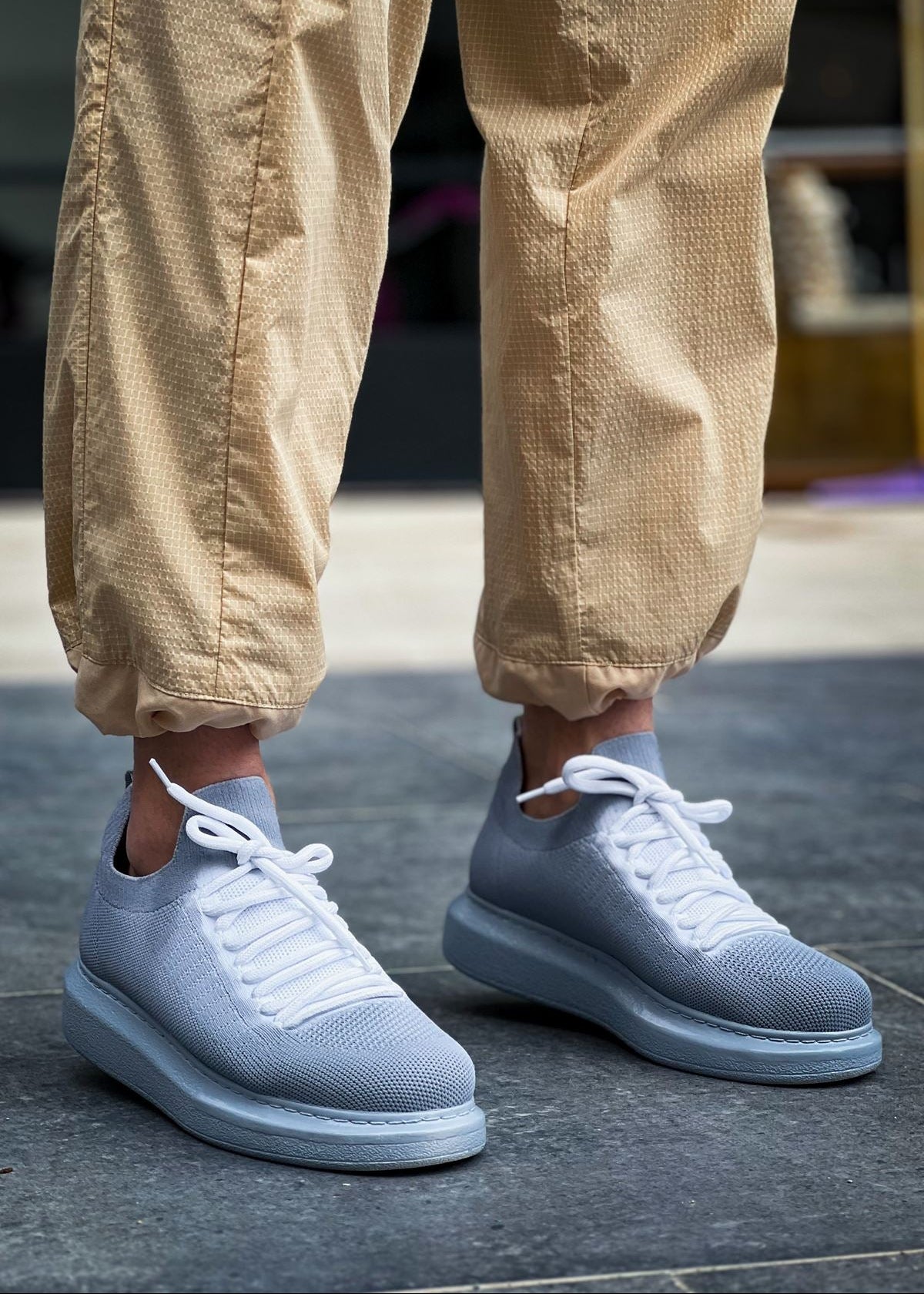 Light grey knit Torino Grey Peak sneakers with white laces and cushioned sole.